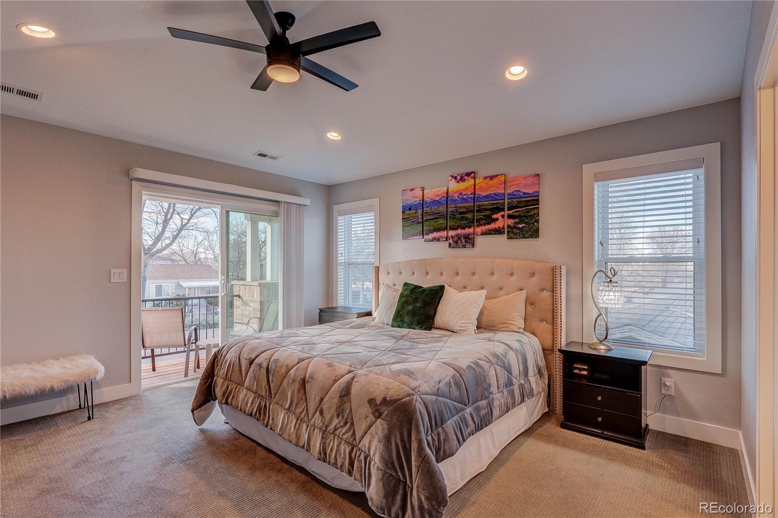 4792 South Acoma Street Englewood, CO 80110 - Photo 9 of 19 a bedroom with a bed and a flat screen tv