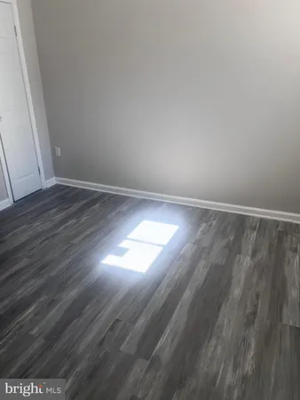 a view of an empty room and wooden floor