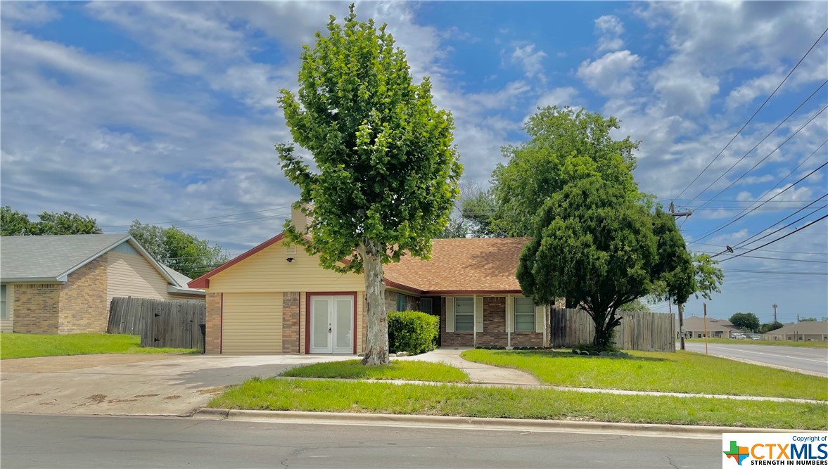 1714 Becker Drive Killeen, TX 76543 - Photo 1 of 1 a front view of a house with a garden and trees