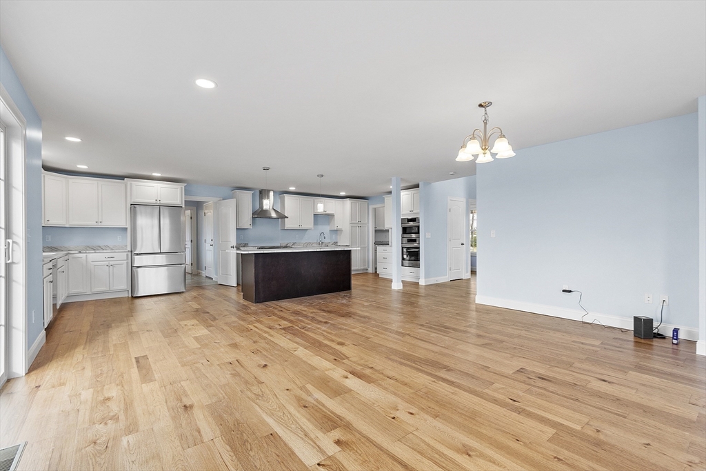 186 Justice Hill Road, Unit MOD FARM Sterling, MA 01564 - Photo 11 of 29 a view of empty room with wooden floor