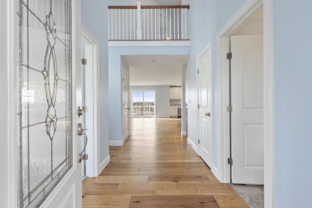186 Justice Hill Road, Unit MOD FARM Sterling, MA 01564 - Photo 17 of 29 a view of a hallway with wooden floor and staircase
