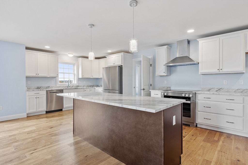 186 Justice Hill Road, Unit MOD FARM Sterling, MA 01564 - Photo 2 of 29 a kitchen with stainless steel appliances granite countertop a sink stove and refrigerator