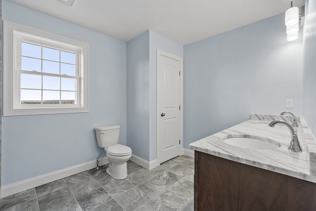 186 Justice Hill Road, Unit MOD FARM Sterling, MA 01564 - Photo 22 of 29 a bathroom with a sink and a toilet
