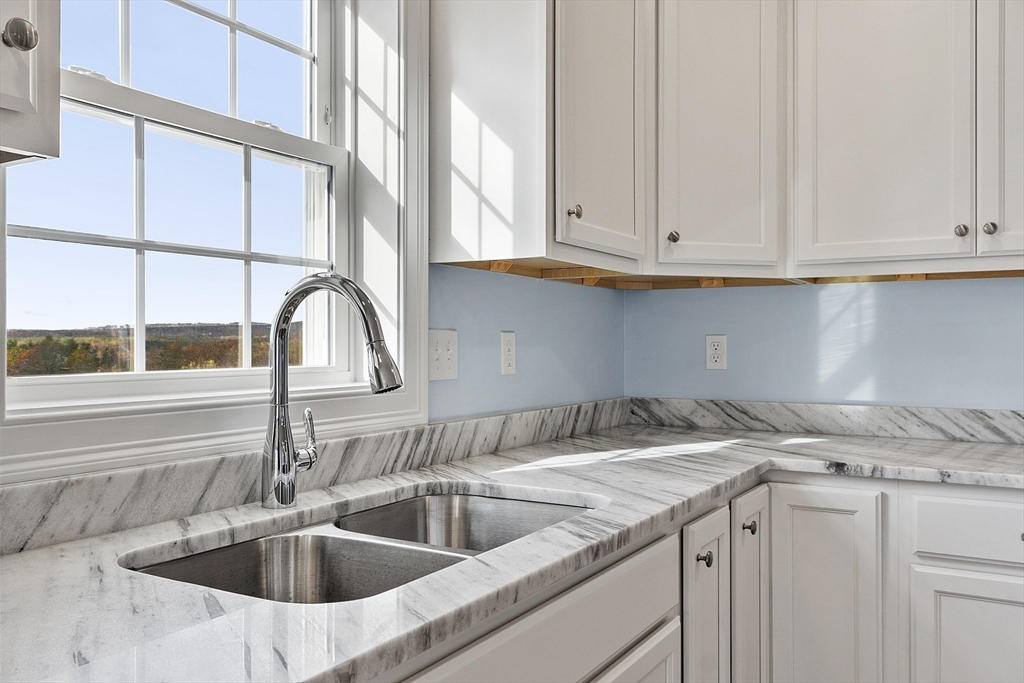 186 Justice Hill Road, Unit MOD FARM Sterling, MA 01564 - Photo 6 of 29 a kitchen with granite countertop a sink and cabinets