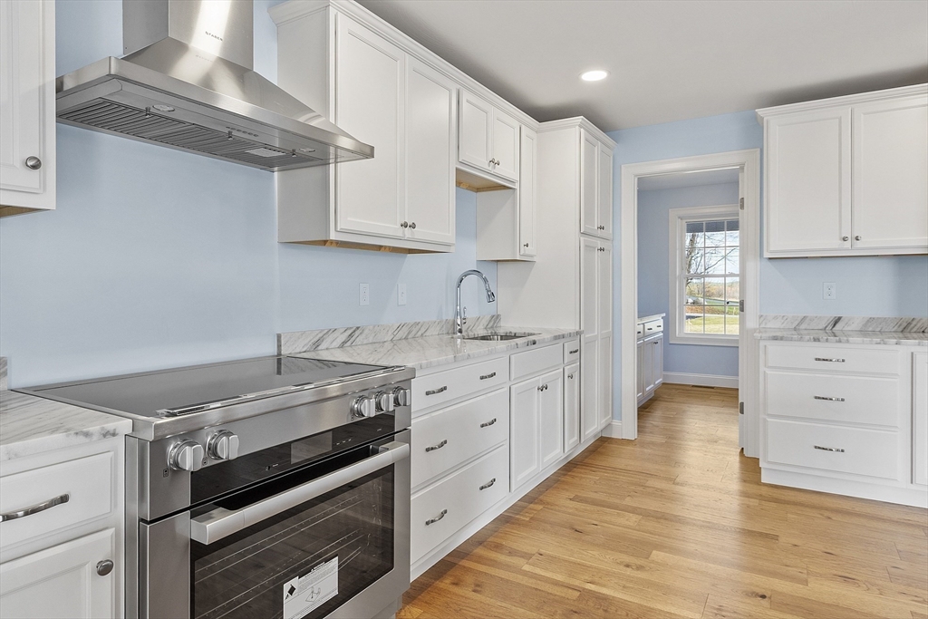 186 Justice Hill Road, Unit MOD FARM Sterling, MA 01564 - Photo 8 of 29 a kitchen with cabinets appliances and a wooden floor