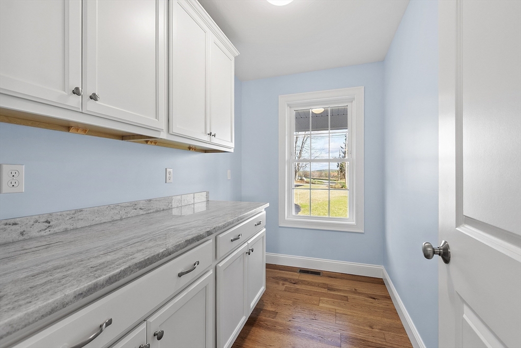 186 Justice Hill Road, Unit MOD FARM Sterling, MA 01564 - Photo 9 of 29 a kitchen with granite countertop white cabinets and window