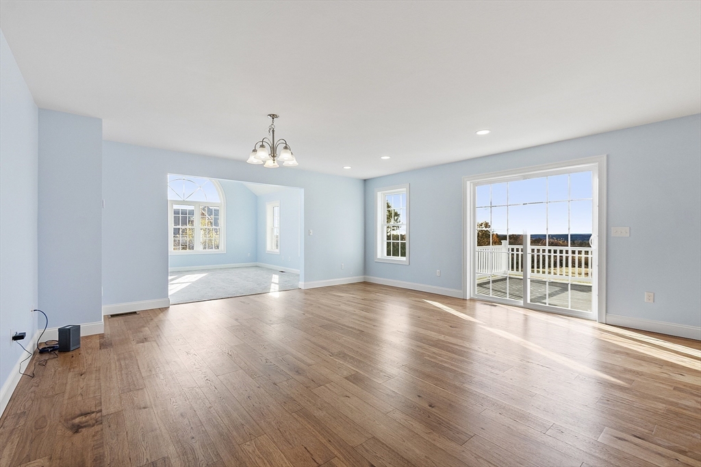 186 Justice Hill Road, Unit MOD FARM Sterling, MA 01564 - Photo 10 of 29 a view of an empty room with wooden floor and a window