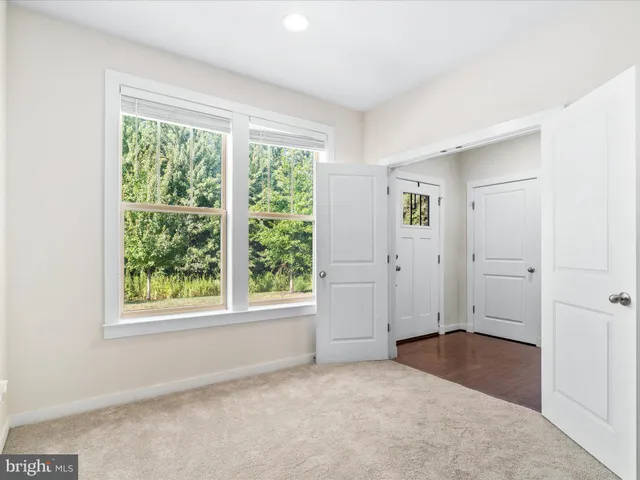 an empty room with windows and closet