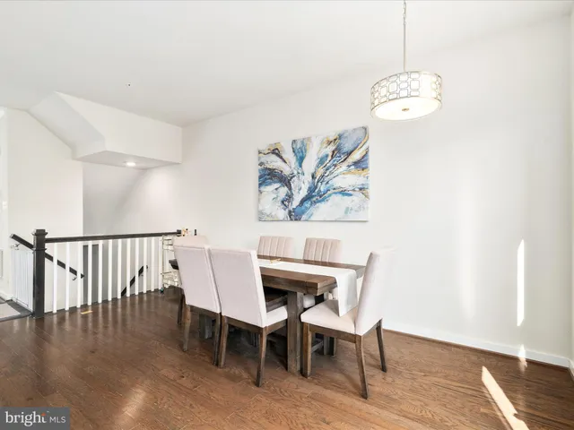 a view of a dining room with furniture wooden floor and chandelier
