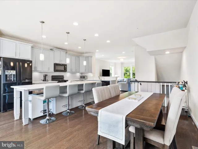 a view of kitchen with cabinets table and chairs