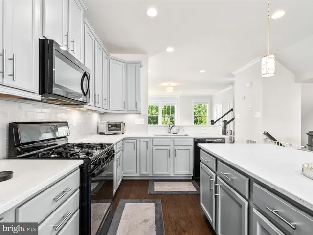 a kitchen with a sink stove and microwave