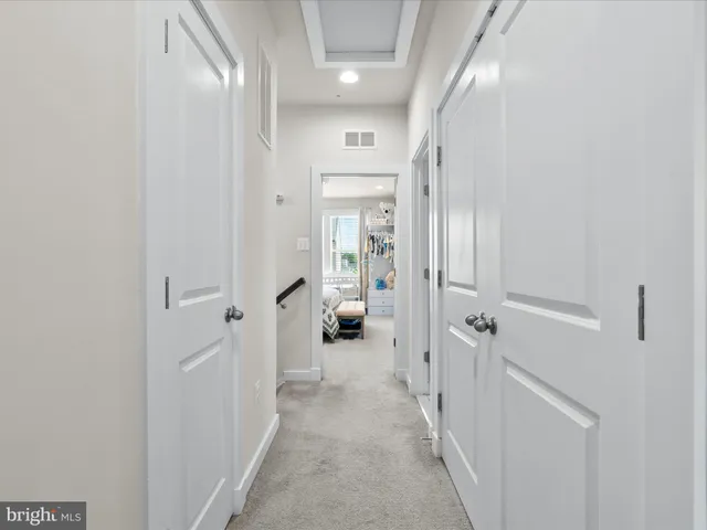 a hallway with white doors