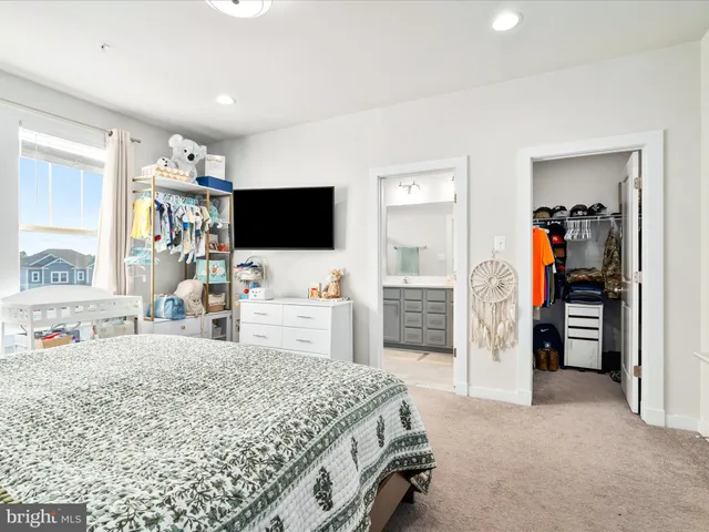 a bedroom with furniture and a flat screen tv