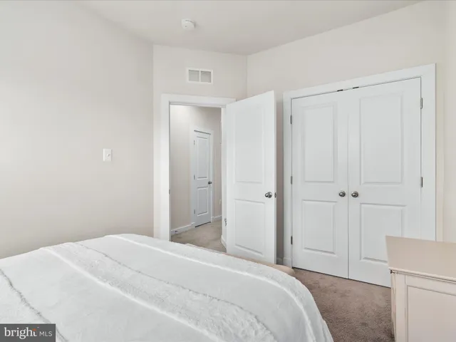 a bedroom with a bed and a cabinet
