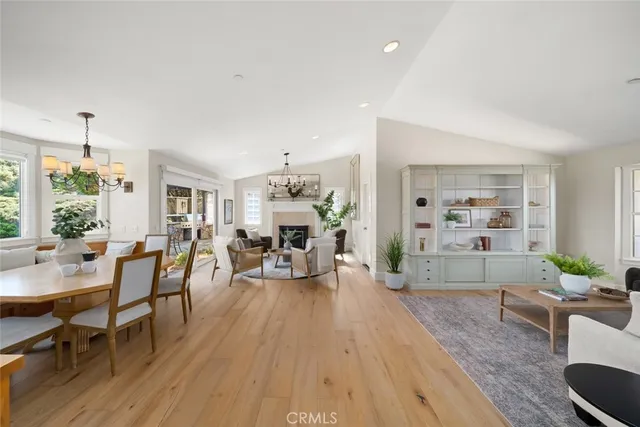 a living room with furniture a fireplace and a large window