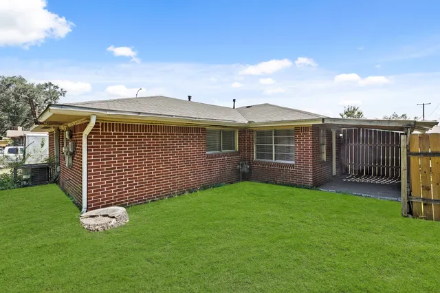 a view of a house with a yard and deck