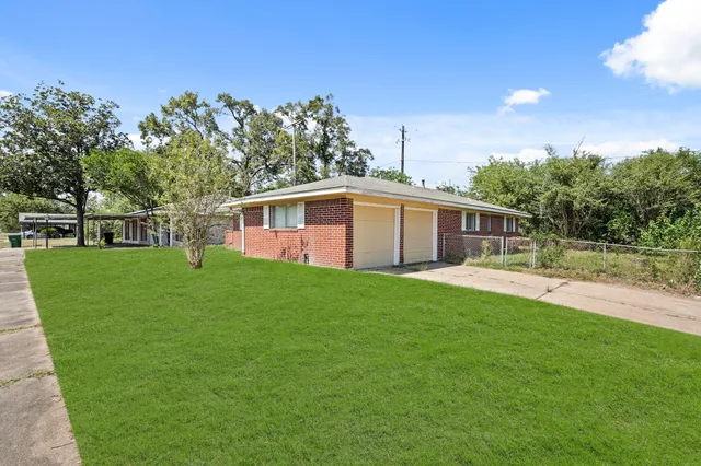 a front view of house with yard and green space
