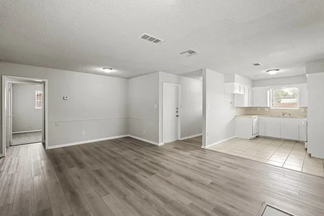 a view of a kitchen with wooden floor and a kitchen