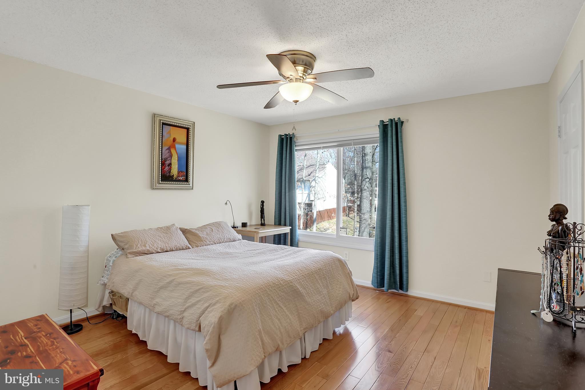 2413 Southgate Square Reston, VA 20191 - Photo 13 of 26 a bedroom with a bed and a chandelier