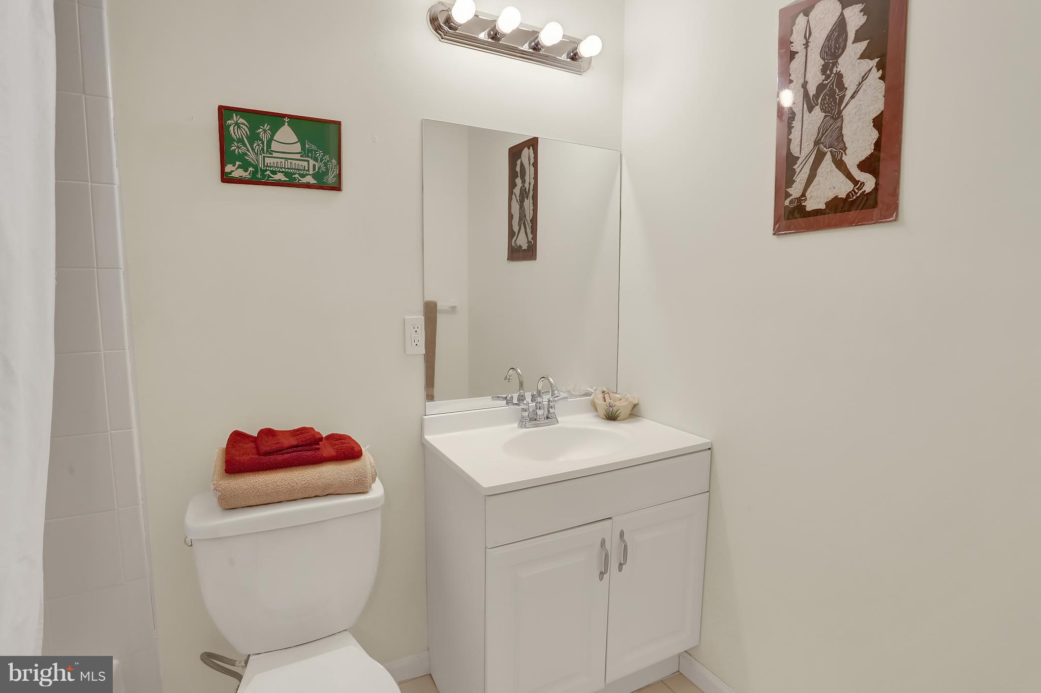 2413 Southgate Square Reston, VA 20191 - Photo 14 of 26 a bathroom with a toilet sink vanity and mirror