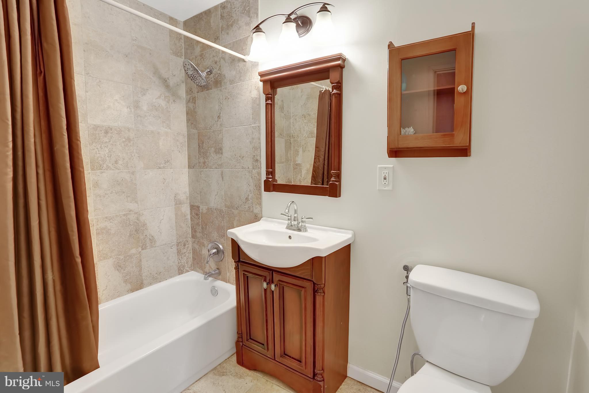 2413 Southgate Square Reston, VA 20191 - Photo 17 of 26 a bathroom with a sink a toilet and bathtub