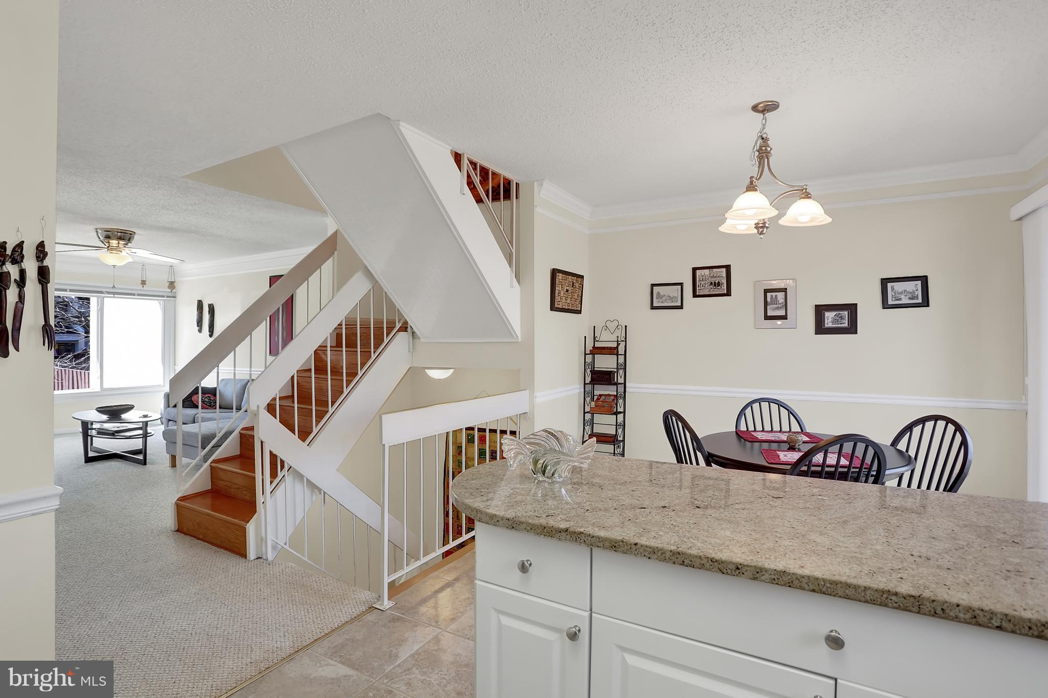 2413 Southgate Square Reston, VA 20191 - Photo 3 of 26 a living room with lots of furniture and stairs