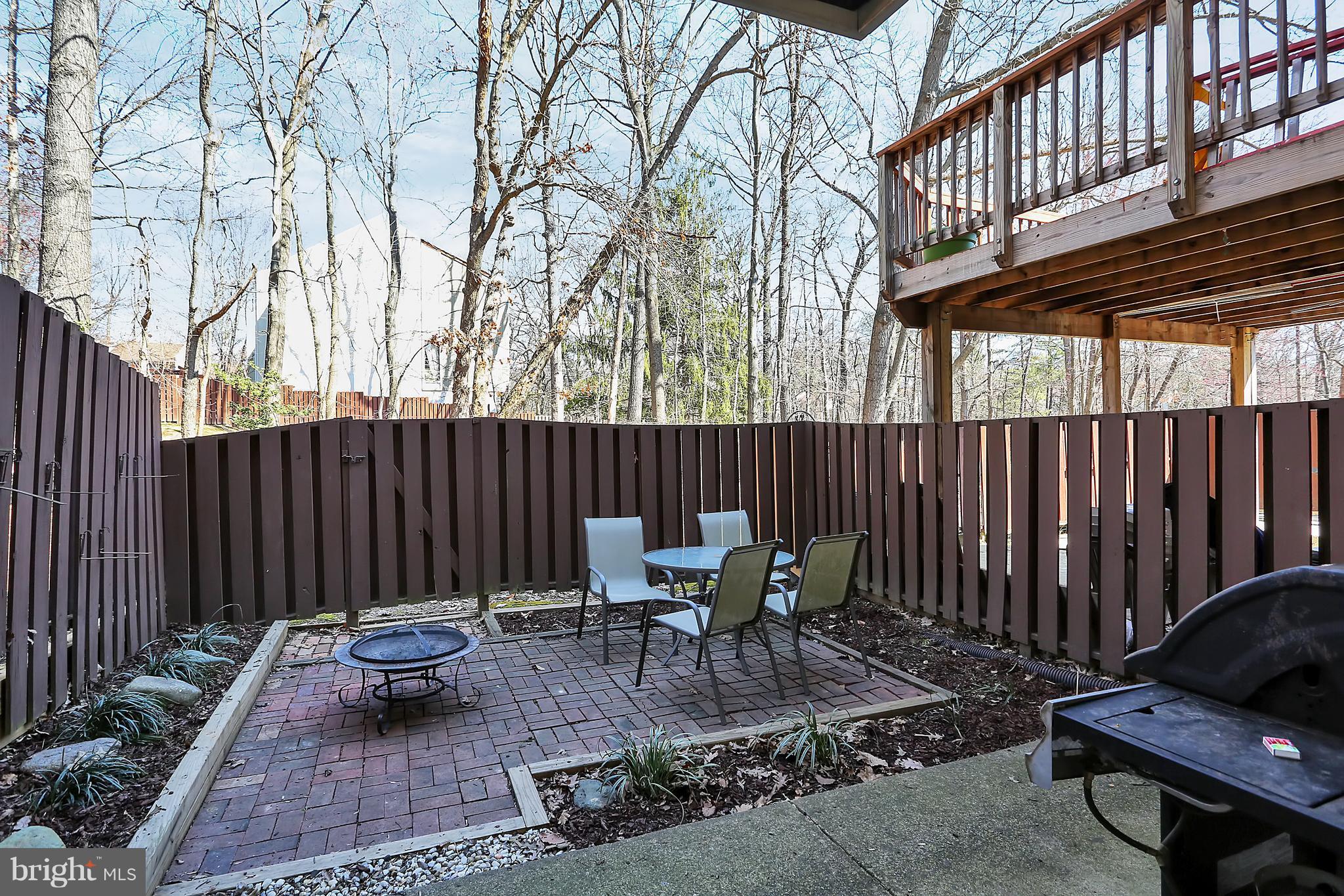 2413 Southgate Square Reston, VA 20191 - Photo 25 of 26 a backyard of a house with table and chairs
