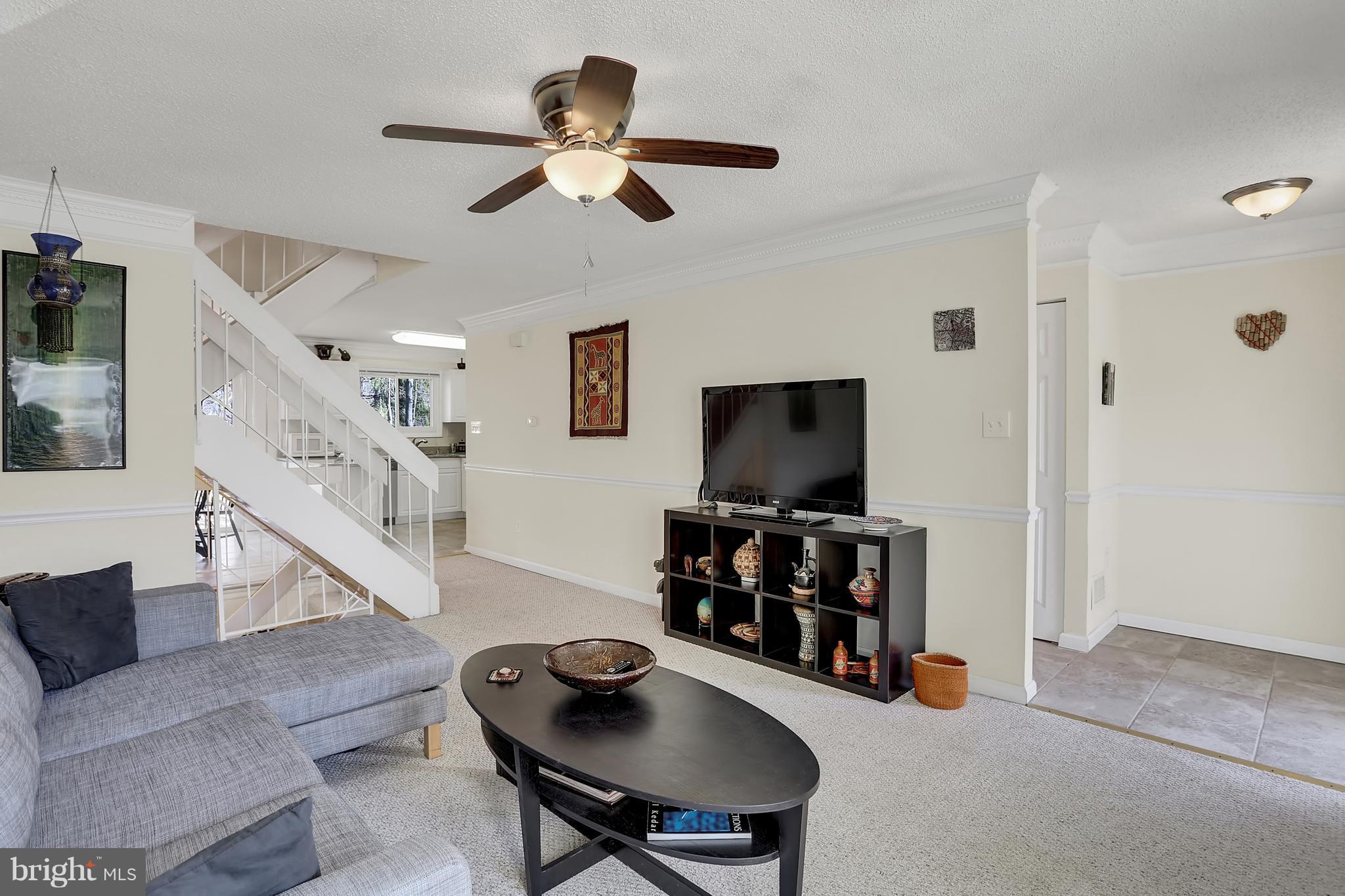 2413 Southgate Square Reston, VA 20191 - Photo 6 of 26 a living room with furniture and a flat screen tv