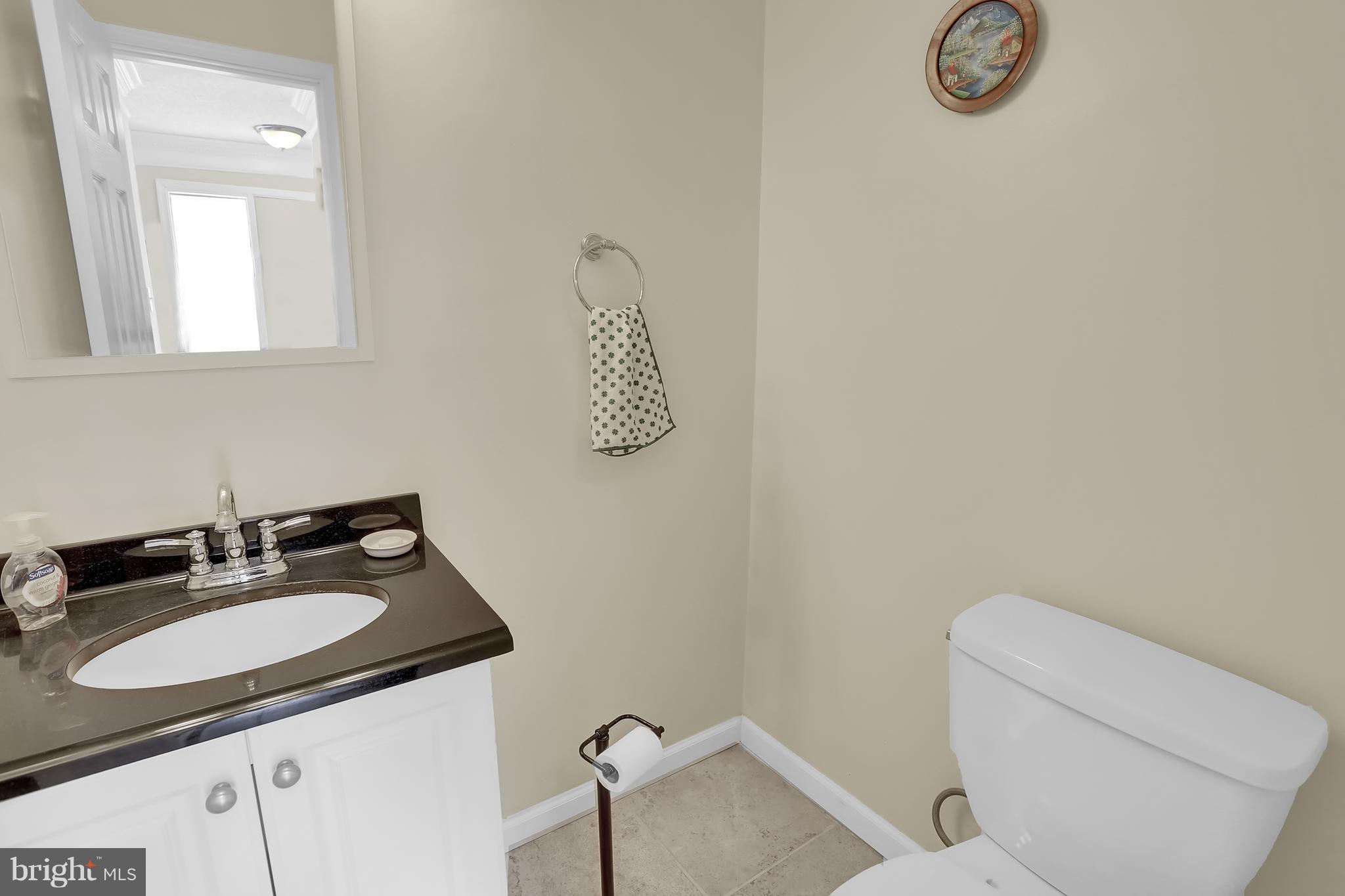 2413 Southgate Square Reston, VA 20191 - Photo 10 of 26 a bathroom with a toilet sink vanity and mirror