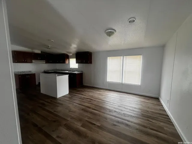 a view of kitchen with microwave oven stove and cabinets