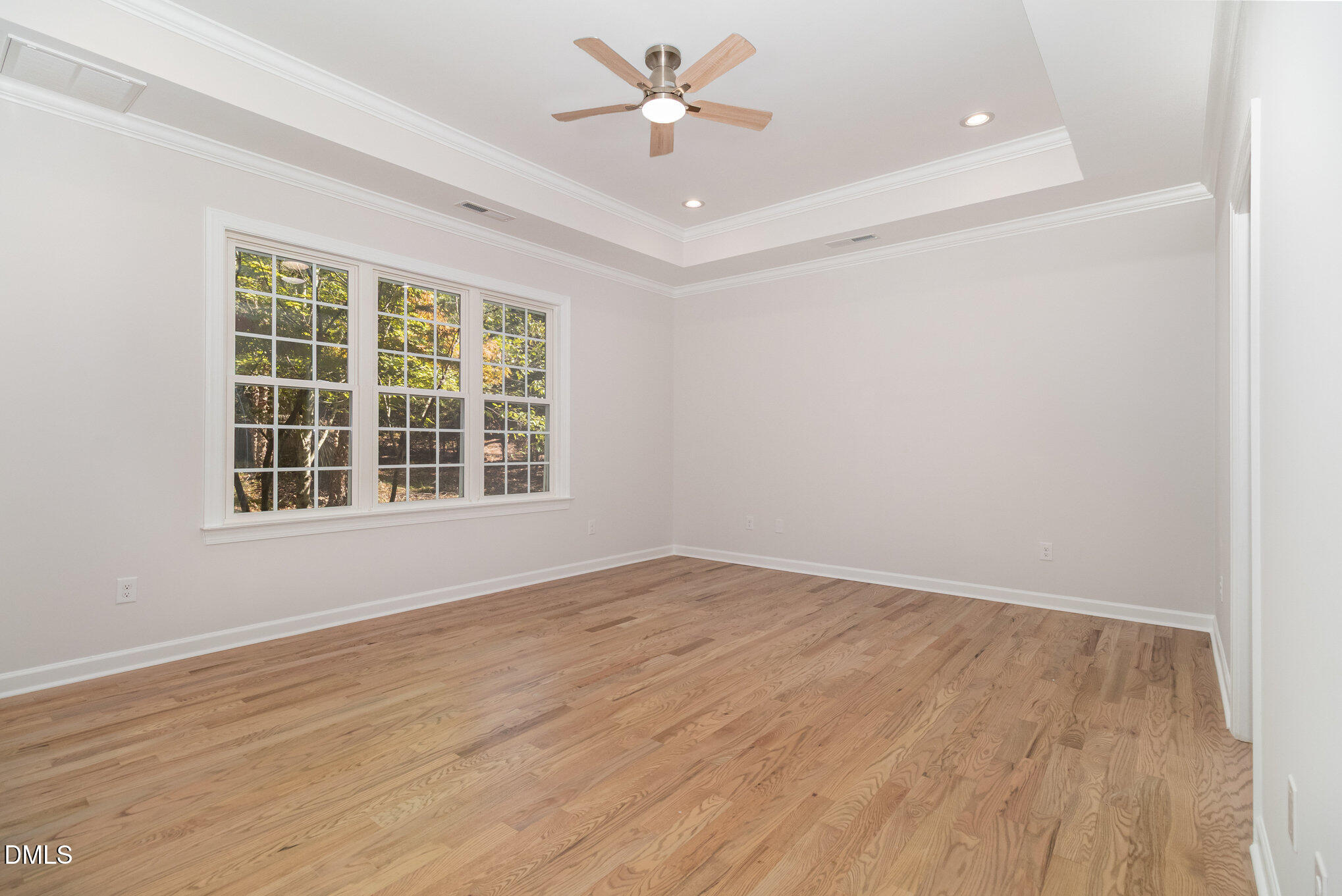 42 Racquet Court Sanford, NC 27332 - Photo 12 of 23 a view of an empty room with a window and wooden floor