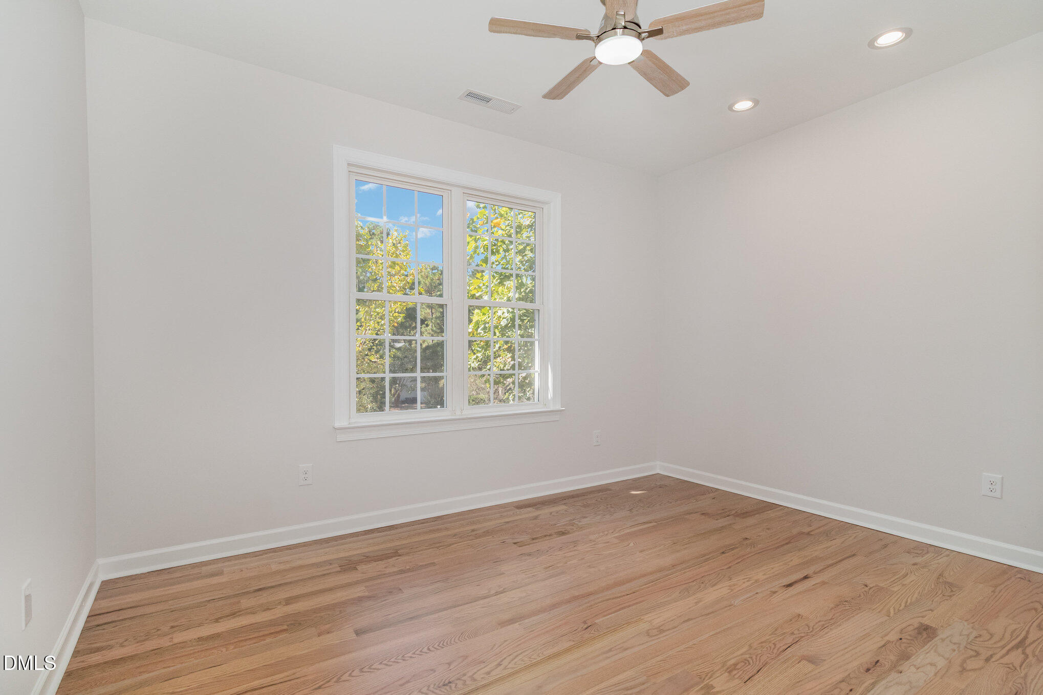 42 Racquet Court Sanford, NC 27332 - Photo 15 of 23 an empty room with wooden floor fan and windows