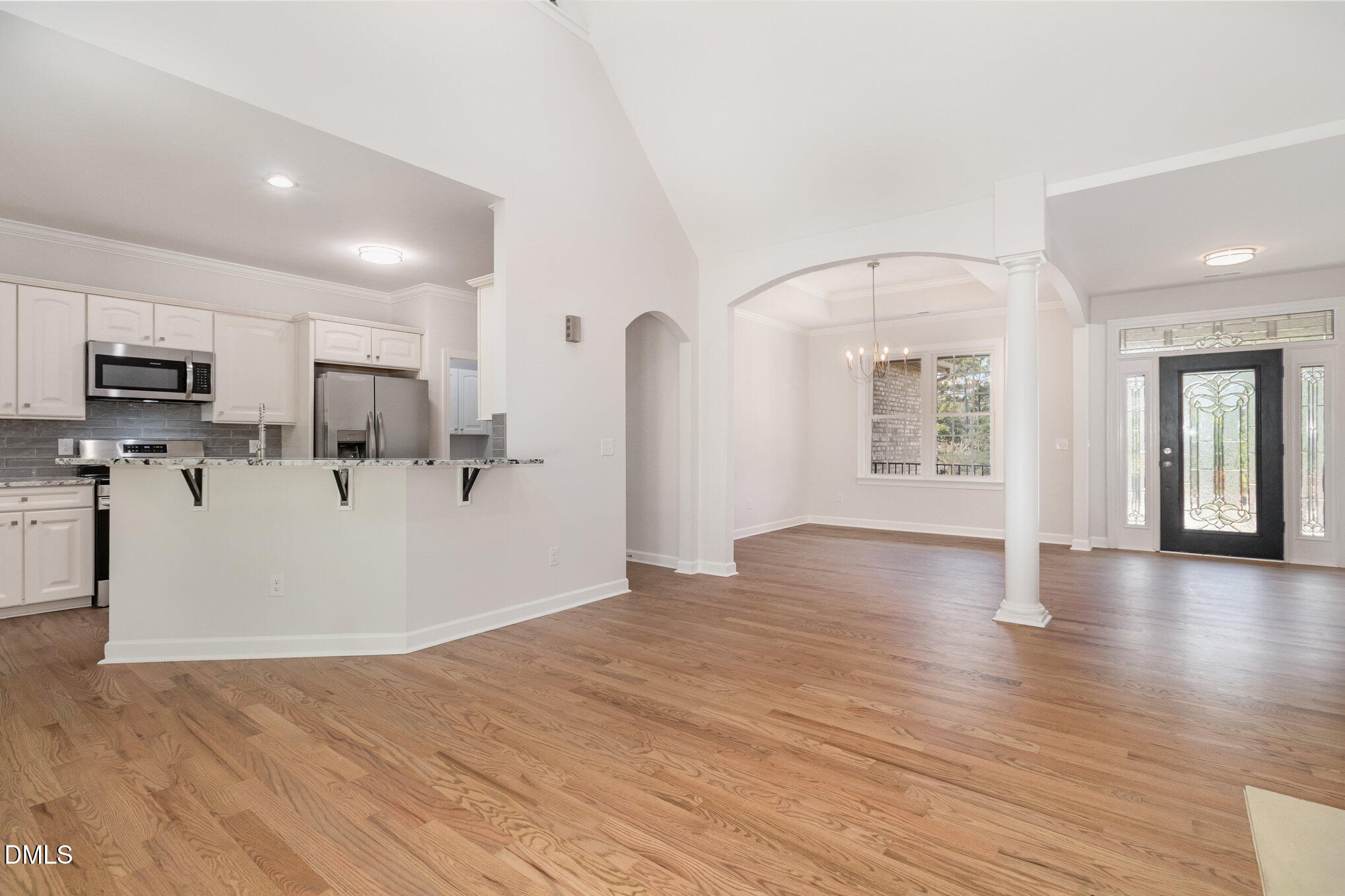 42 Racquet Court Sanford, NC 27332 - Photo 7 of 23 a view of a living room with kitchen appliances and wooden floor