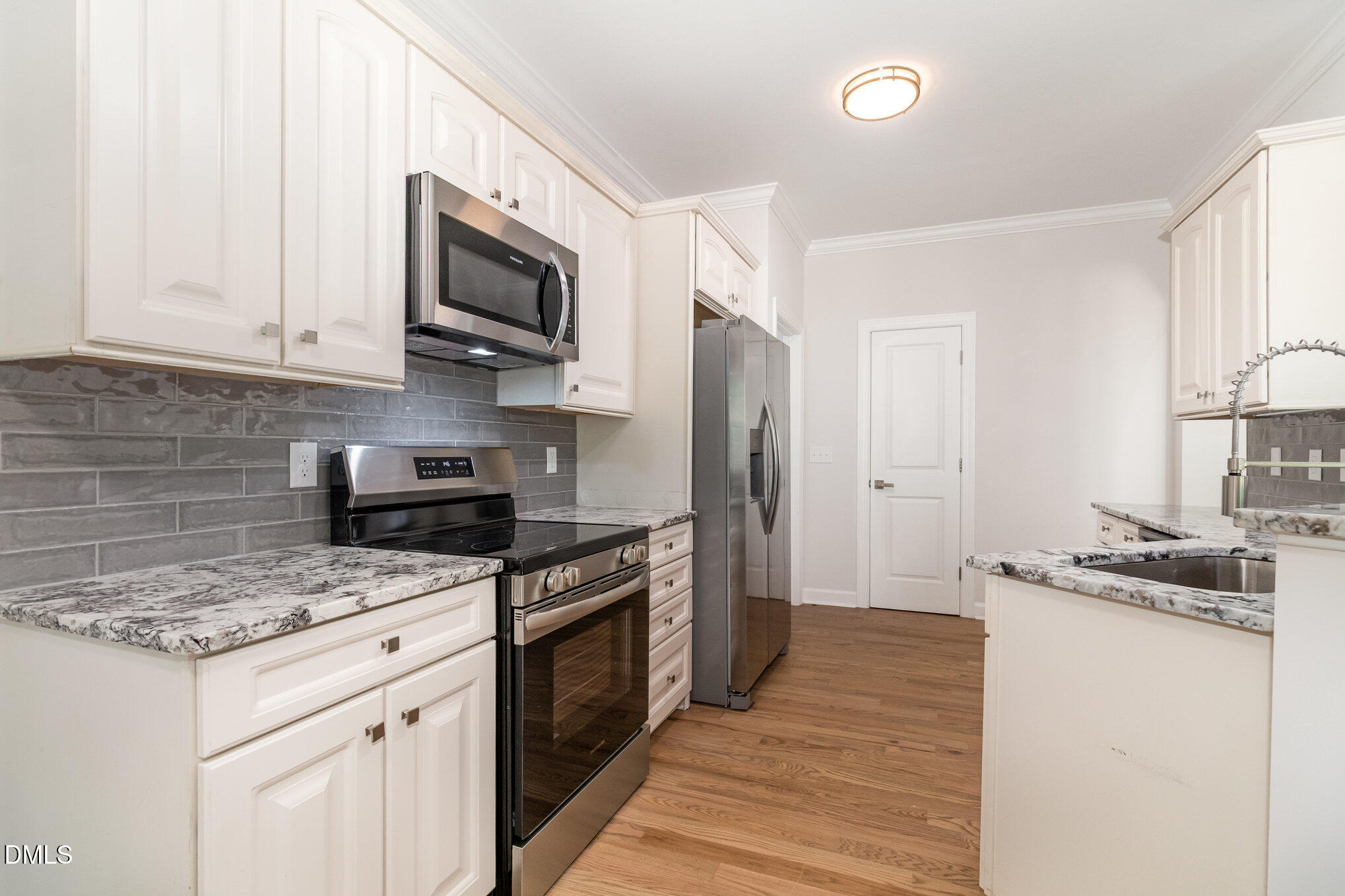 42 Racquet Court Sanford, NC 27332 - Photo 9 of 23 a kitchen with stainless steel appliances granite countertop a stove a sink dishwasher a refrigerator and a microwave