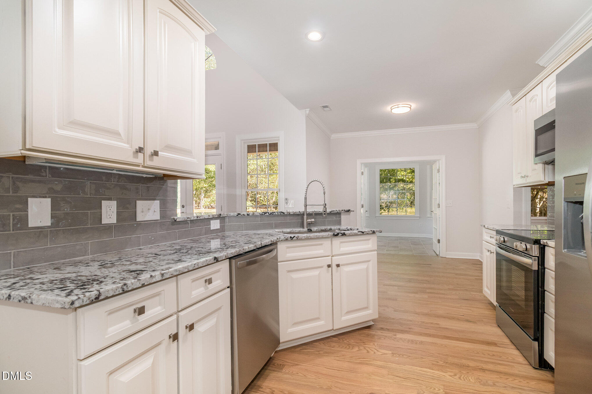 42 Racquet Court Sanford, NC 27332 - Photo 10 of 23 a kitchen with stainless steel appliances granite countertop a stove a sink and a granite counter tops