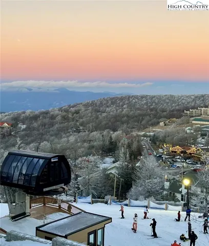 a view of a terrace with a table and chairs under an umbrella