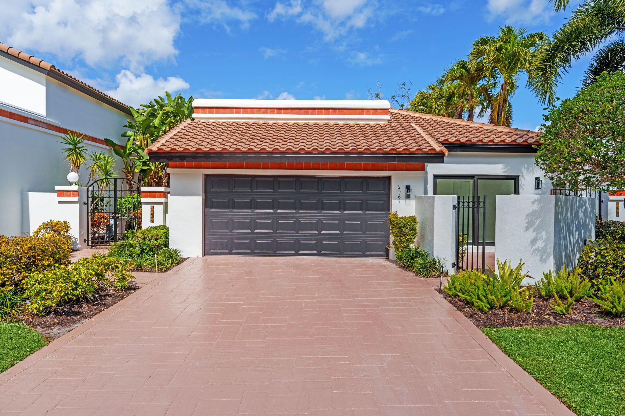 a front view of a house with a garden
