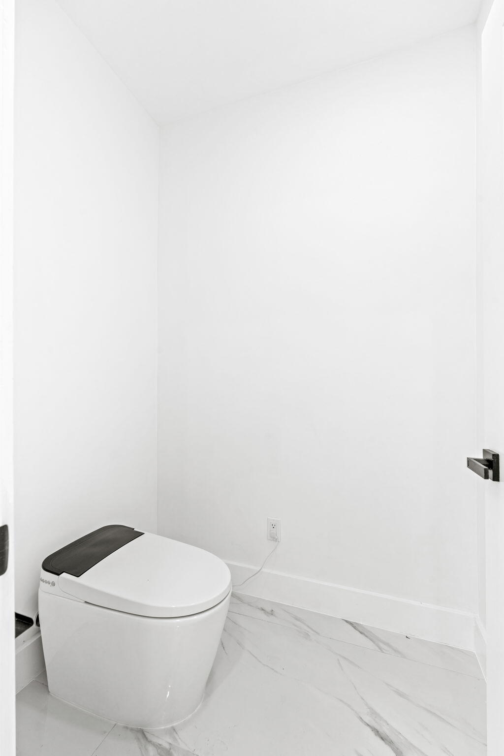 6567 Via Benita Boca Raton, FL 33433 - Photo 24 of 63 a white toilet sitting next to a white sink