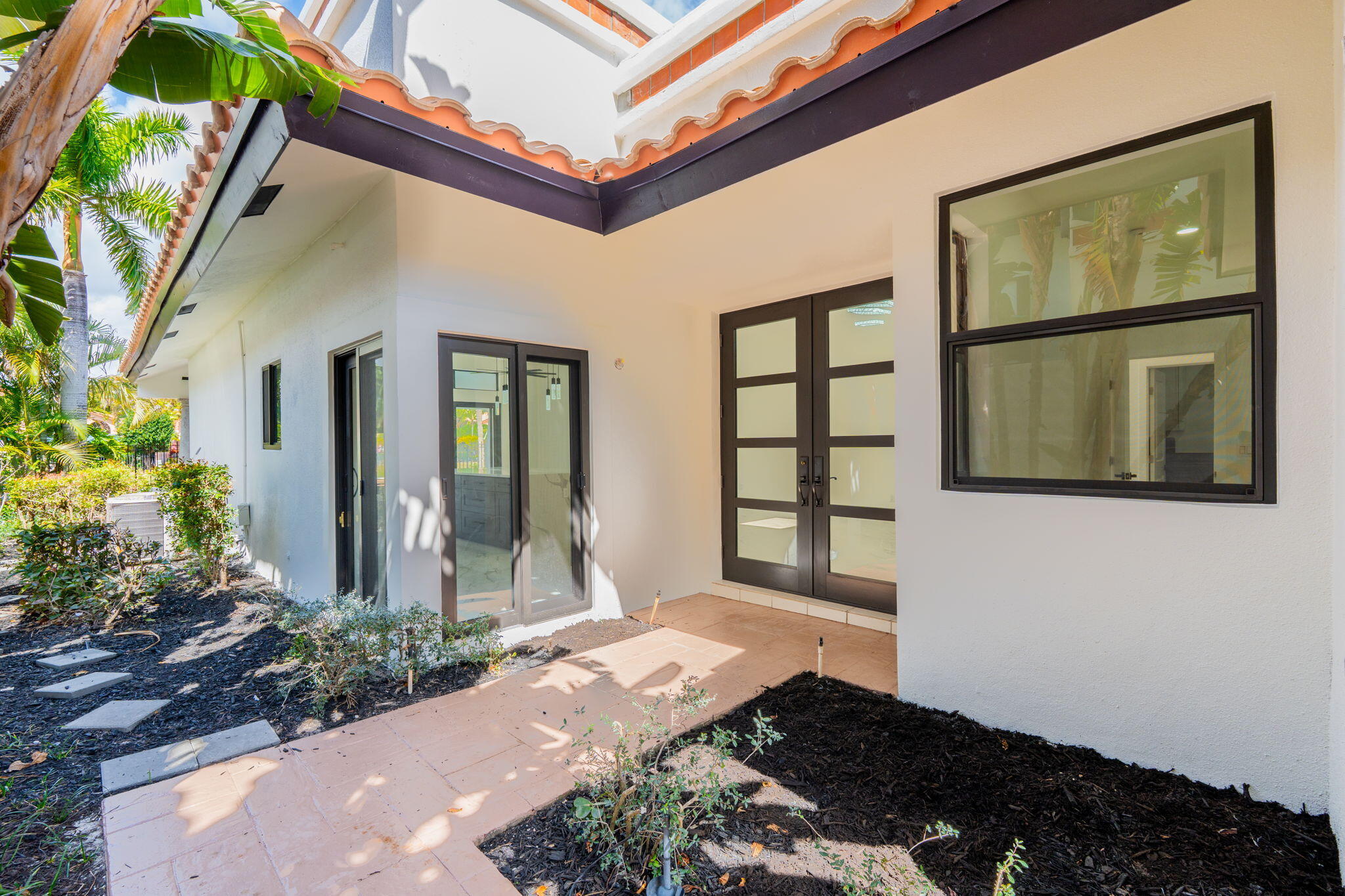 6567 Via Benita Boca Raton, FL 33433 - Photo 6 of 63 a front view of a house with a yard