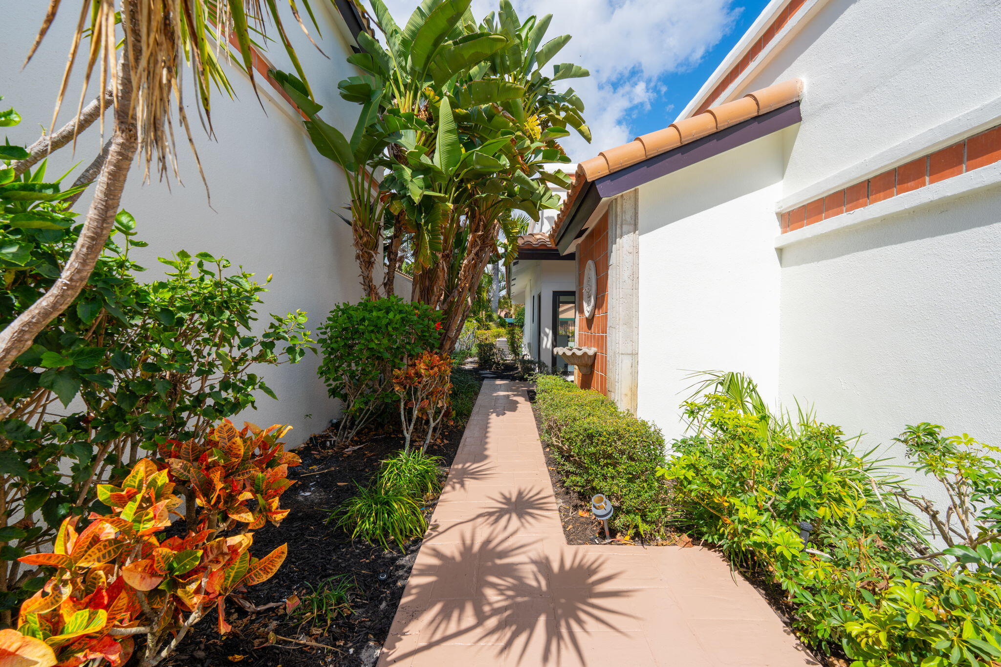 6567 Via Benita Boca Raton, FL 33433 - Photo 8 of 63 a view of a pathway with a flower garden