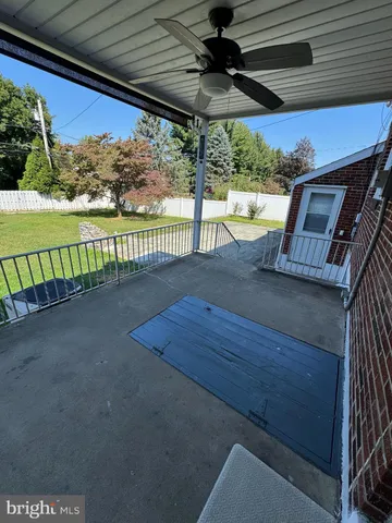 a bathroom with a granite countertop sink mirror bathtub and toilet