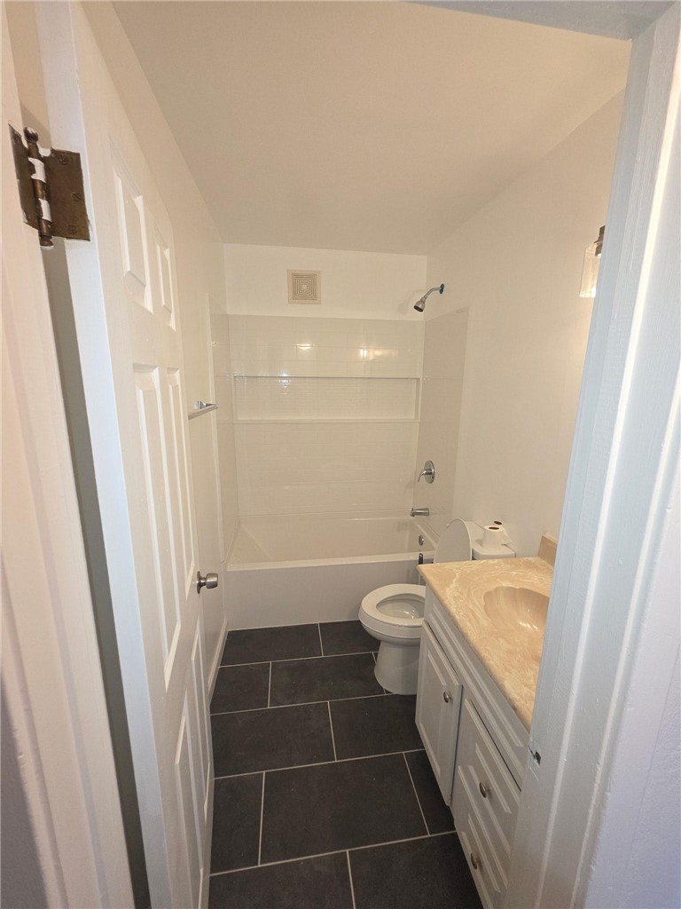 512 E Street Needles, CA 92363 - Photo 8 of 20 a bathroom with a sink a toilet a tub and a shower