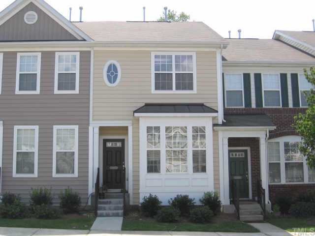 a front view of a house with yard and green space