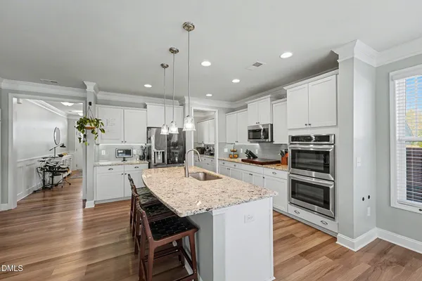 a bathroom with a granite countertop sink toilet and a mirror