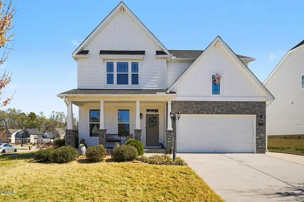 a view of a white house with a yard