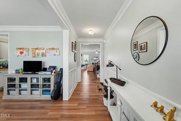 a kitchen with stainless steel appliances a dining table chairs refrigerator and microwave