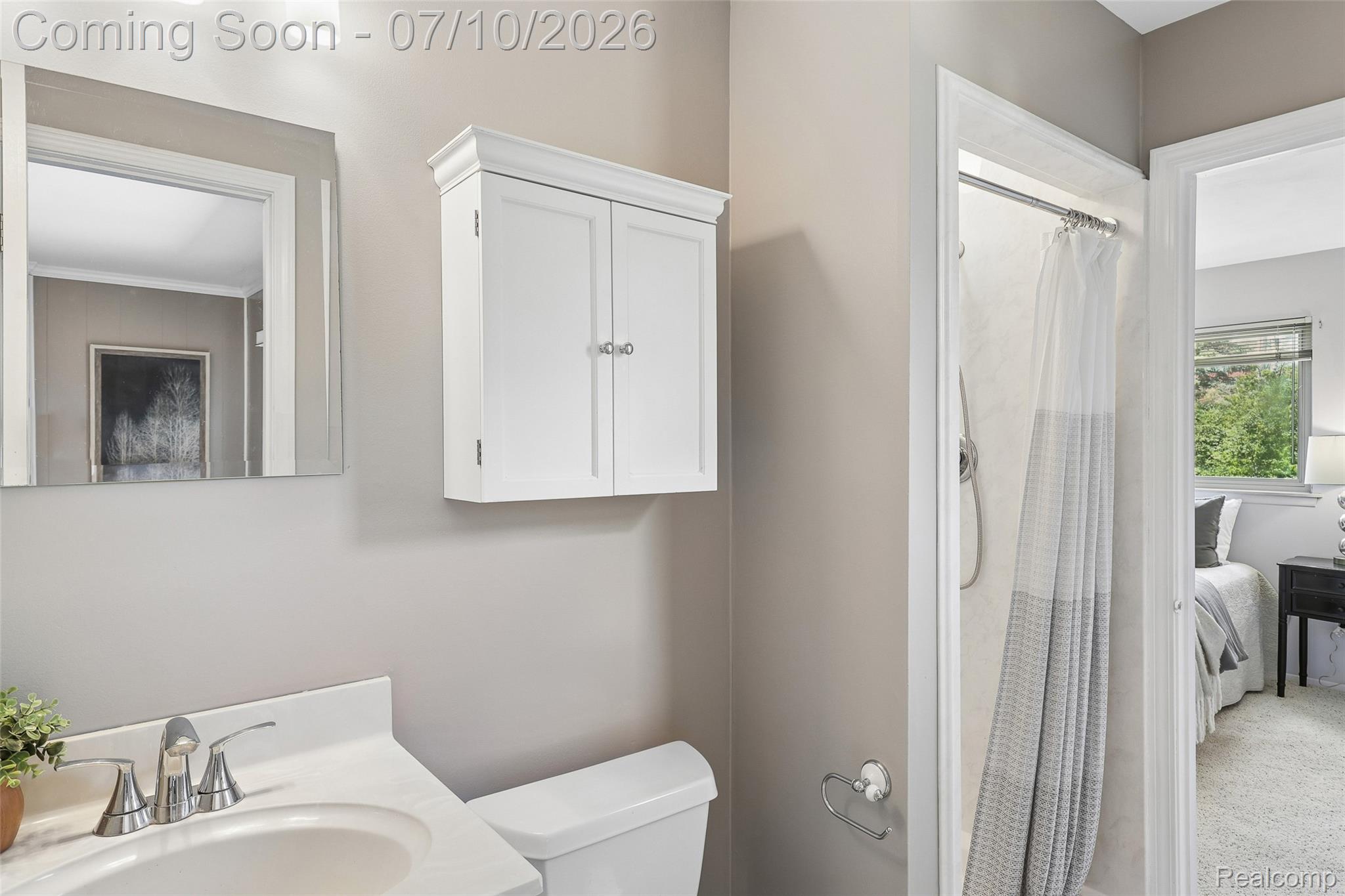42698 Keystone Canton, MI 48187 - Photo 19 of 33 Bathroom vanity with a chrome faucet, white countertop, and wall-mounted mirror