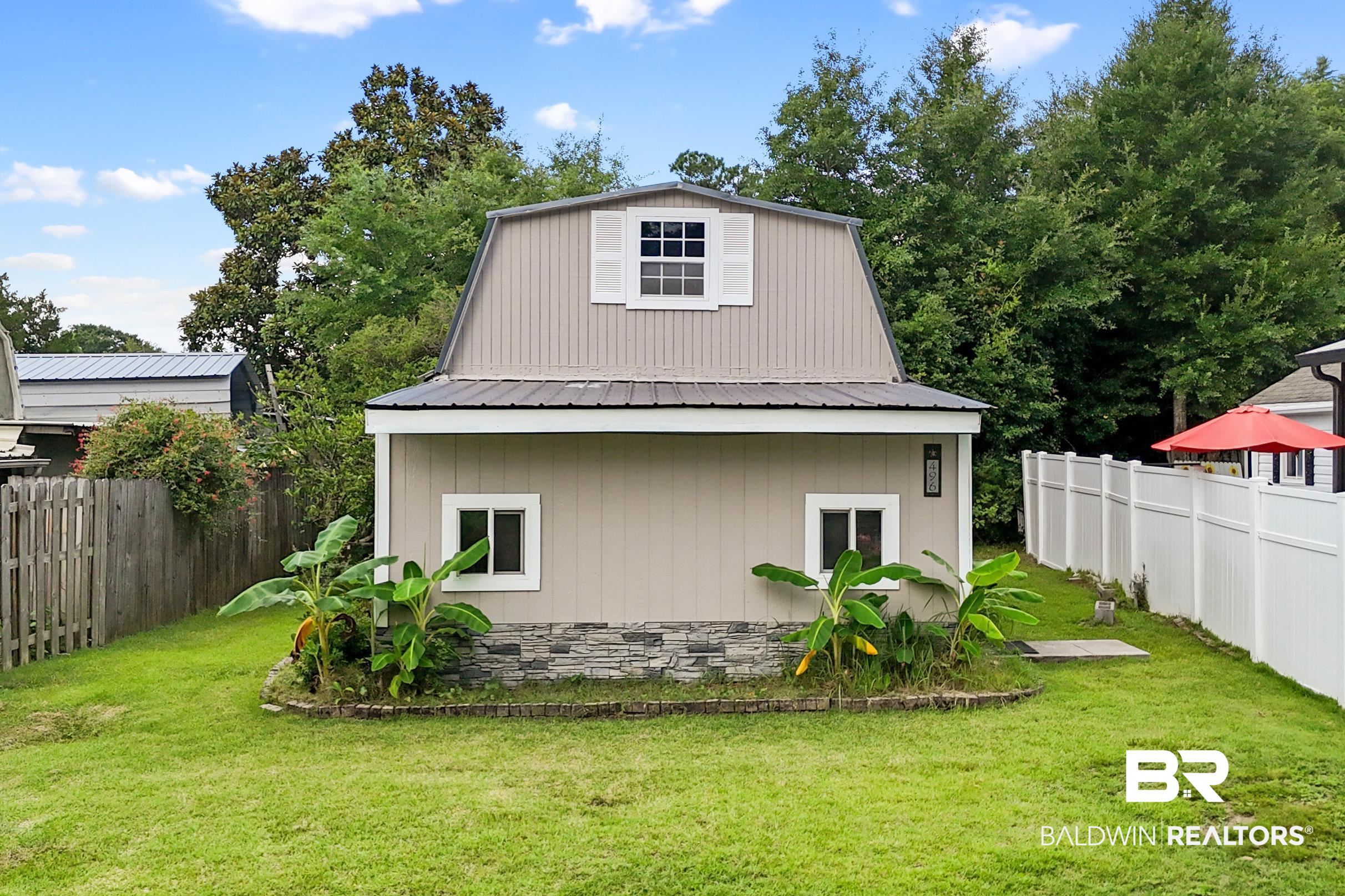 496 Elberta Loop Lillian, AL 36549 - Photo 19 of 29 View of property exterior featuring a metal roof