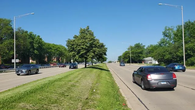 a view of a back yard of the house with parked cars
