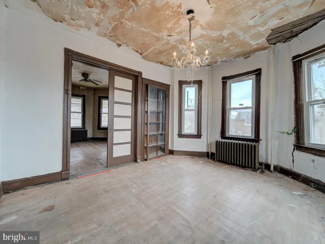 an empty room with windows and closet